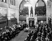 Lord Tweedsmuir, Governor General of Canada (1935-1940), reads the Speech from the Throne. Date: January 27, 1938. Photographer: National Film Board of Canada. Reference: Library and Archives Canada, PA-801226.